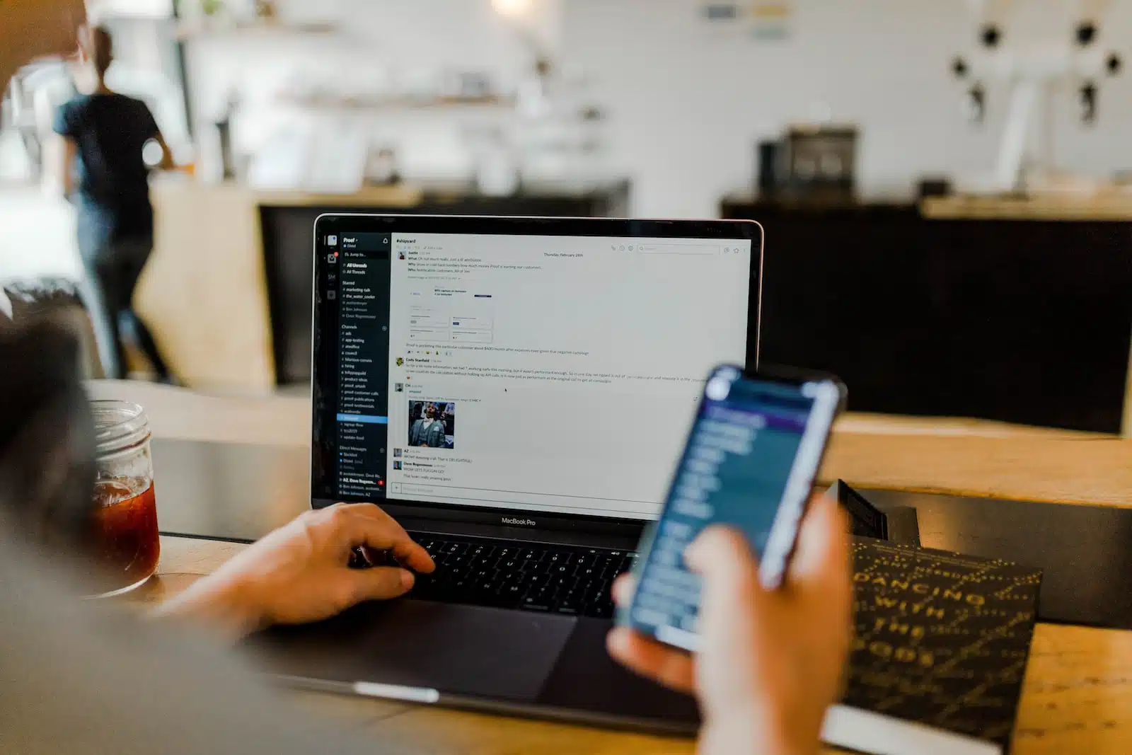 Foto von Austin Distel person using phone and laptop